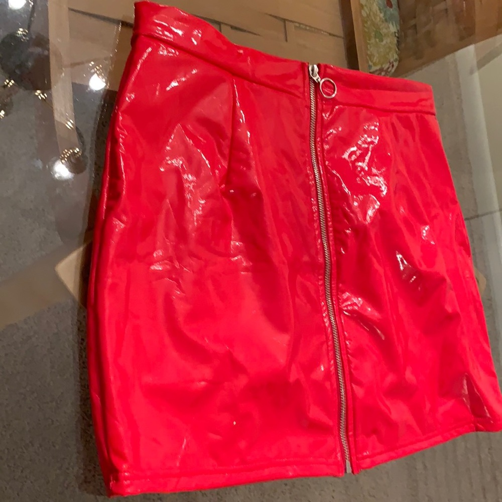 Shiny tight red polyester/ spandex skirt. Looks like p/leather. Size XL